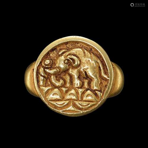 . A solid gold ring with an incised bezel of an elephant Jav...