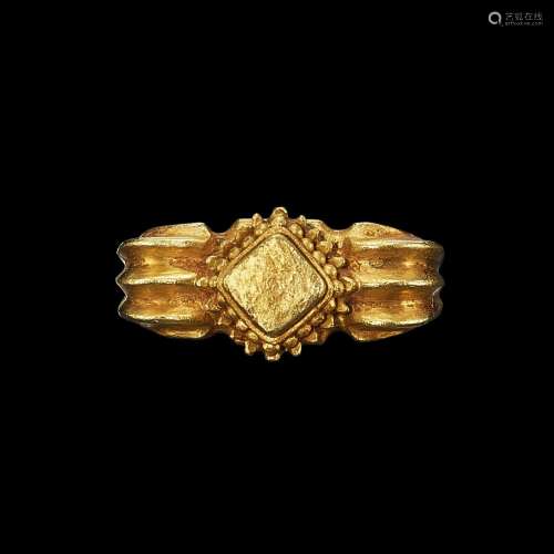 . A solid gold ring with vertical rib shank Java, Indonesia,...