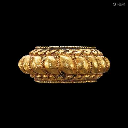 . A gold torsade ring with filigree and incised waves Java, ...
