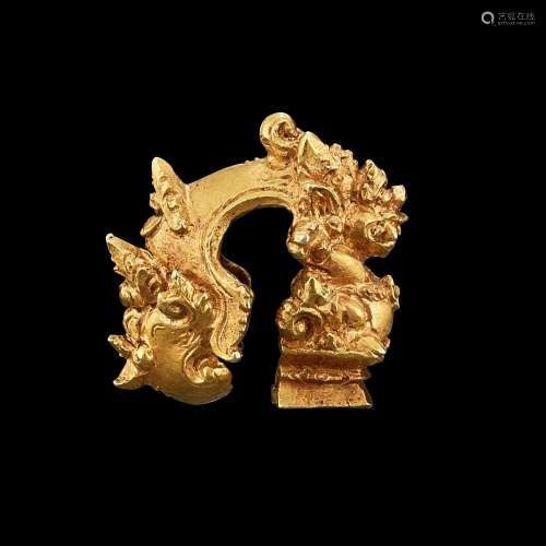 . A solid gold earring with seated Singa Java, Indonesia, 7t...
