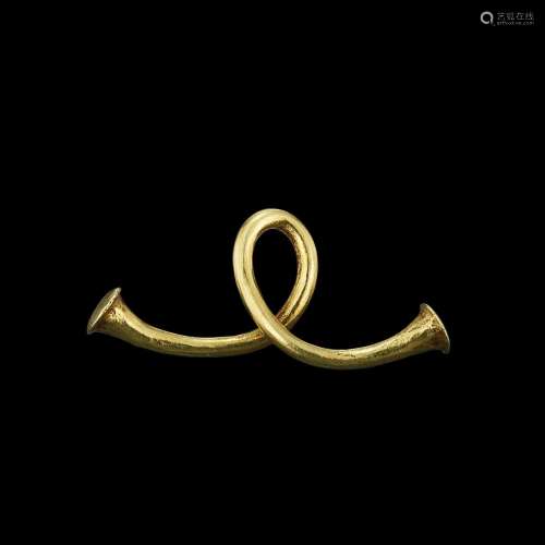 . A looped solid gold earring Java, Indonesia, 7th - 12th ce...
