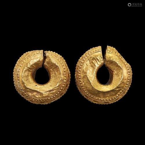 . A large pair of Gandharan earrings decorated with granulat...