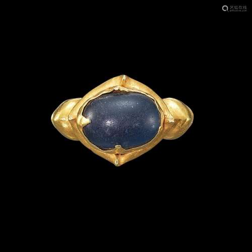 . A gold and blue glass ring with ribbed shank Java, Indones...