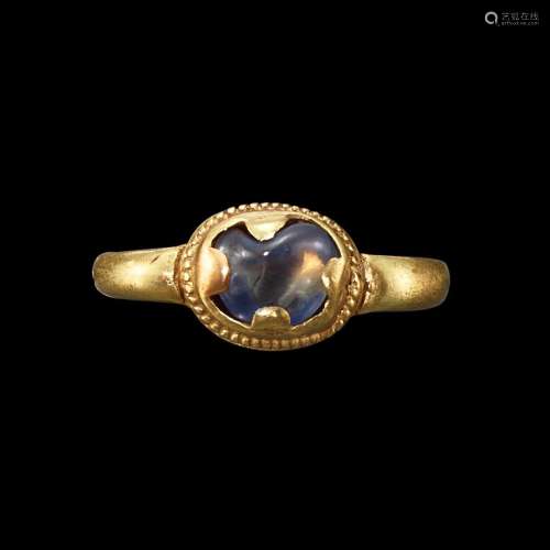 . A solid gold and light blue sapphire ring Java, Indonesia,...