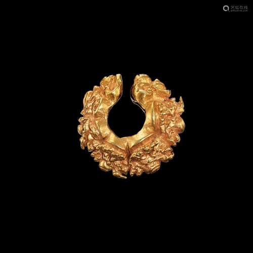 . An ornate solid gold earring Java, Indonesia, 7th - 12th c...