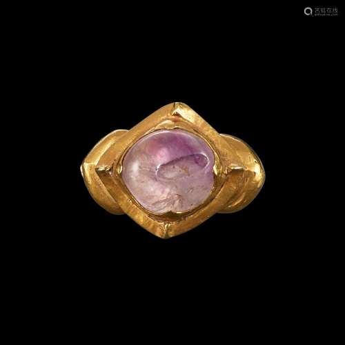 . A gold and amethyst ring with ribbed shank Java, Indonesia...