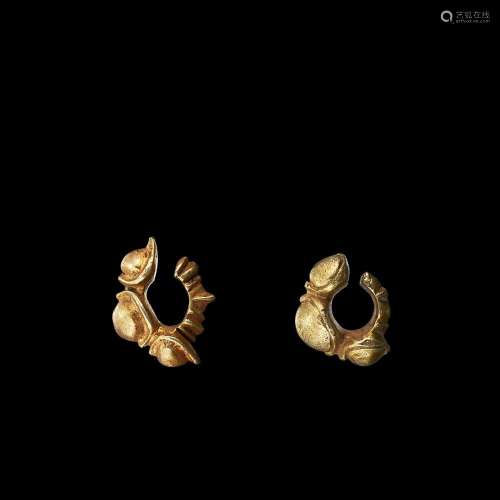 . Two solid gold cabochon-shaped earrings Java, Indonesia, 7...