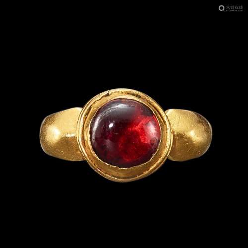 . A gold and garnet cabochon ring Java, Indonesia, 7th - 12t...