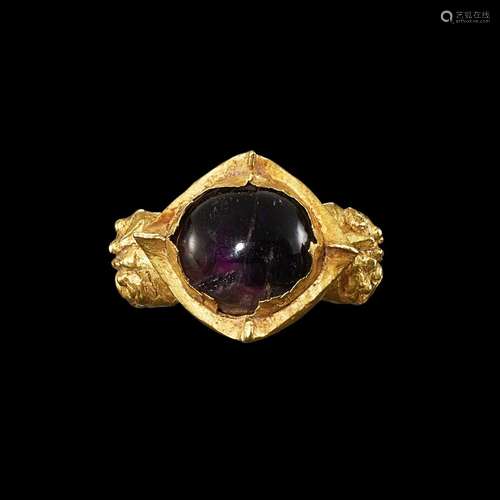 . A gold and crystal ring with protube-ring shoulders Centra...