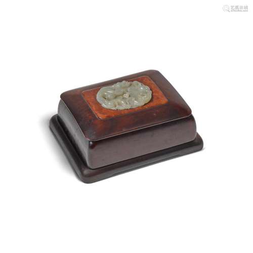 A PALE CELADON JADE PLAQUE MOUNTED TO A HONGMU BOX AND COVER...