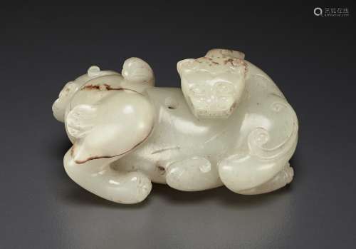 A RARE AND FINELY CARVED WHITE JADE FIGURE OF A MYTHICAL BEA...