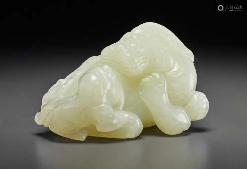 A WHITE JADE FIGURE OF A MYTHICAL BEAST WITH CUB