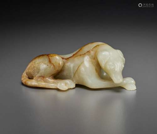 A PALE GREY AND MOTTLED RUSSET JADE FIGURE OF A RECUMBENT HO...