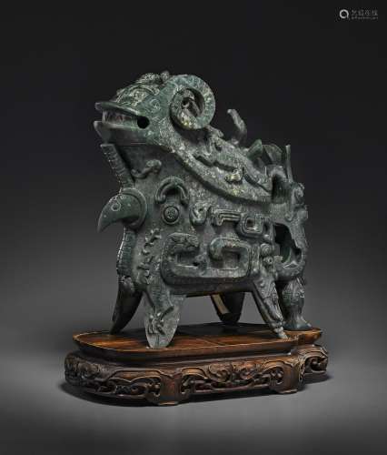 A RARE AND LARGE BLACKISH-GREEN JADE ARCHAISTIC GONG -FORM V...