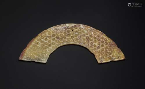 AN ORANGISH-RUSSET JADE ARCHED PENDANT, HUANG