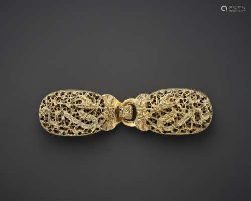 A RETICULATED GILT-BRONZE TWO-PART BELT BUCKLE