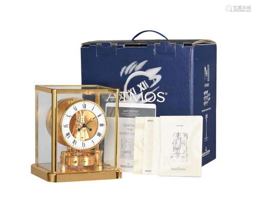 A SWISS GILT BRASS ‘ATMOS’ TIMEPIECE COMPLETE WITH PAPERWORK...