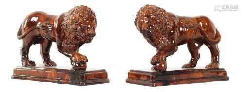 A GOOD PAIR OF 19TH CENTURY TREACLE GLAZED TERRACOTTA MEDICI...