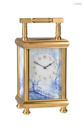 A FRENCH GILT BRASS CARRIAGE TIMEPIECE WITH DELFT STYLE PORC...