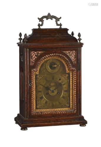 AN AUSTRIAN OAK CASED TABLE CLOCK WITH TRIP-HOUR REPEAT