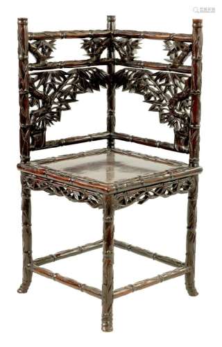 A 19TH CENTURY CHINESE CARVED ROSEWOOD CORNER CHAIR