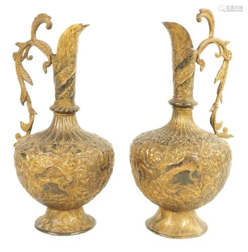 A PAIR OF 19TH CENTURY INDIAN GILT METAL EWERS
