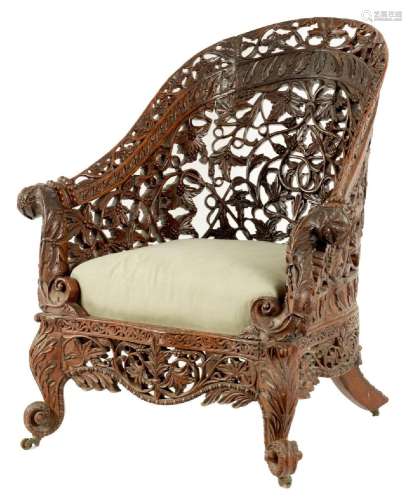 A 19TH CENTURY ANGLO INDIAN CARVED HARDWOOD LIBRARY CHAIR