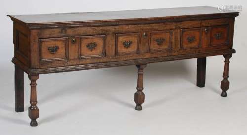 A 17th / 18th century oak dresser, the rectangular plank top...