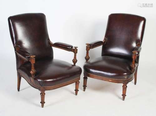 A pair of 20th century leather upholstered armchairs, with t...