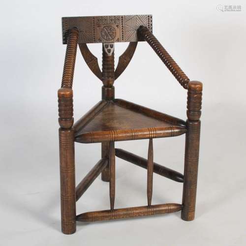 A 19th century oak turner`s chair, of triangular three-post ...