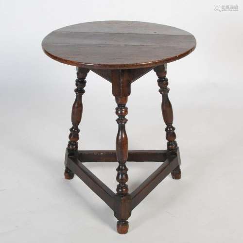 An 18th century oak cricket table, the patinated plank top o...