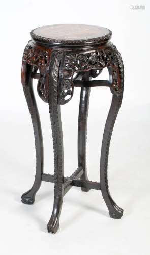 A Chinese carved darkwood stand, Qing Dynasty, the round top...