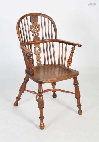 A 19th century yew and elm hoop-back Windsor chair, with a p...