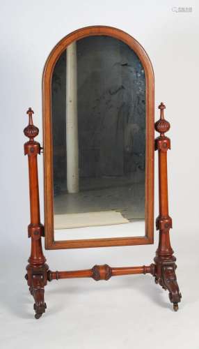 A Victorian mahogany cheval mirror, the arched mirror plate ...