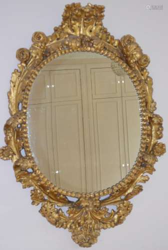 A 19th century gilt wood wall mirror, the flower and foliate...