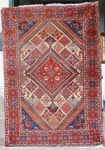 A 20th century Persian carpet, the rich lattice cream field ...