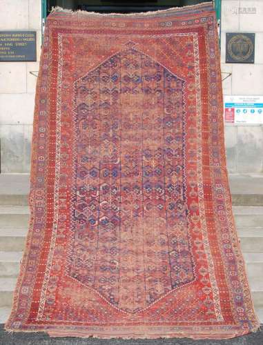 An antique Persian carpet, the indigo field with a dense des...