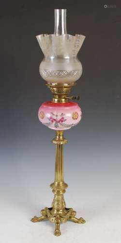 A Victorian brass oil lamp, with pink and opaque white glass...