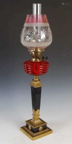 A late 19th / early 20th century ebonised and brass oil lamp...