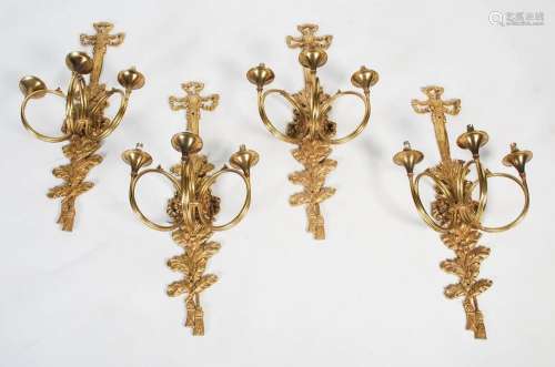 A set of four 20th century cast brass wall appliques, each i...