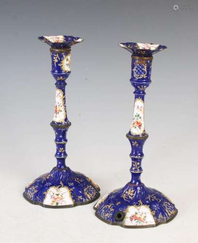 A pair of 18th century English enamel candlesticks, decorate...