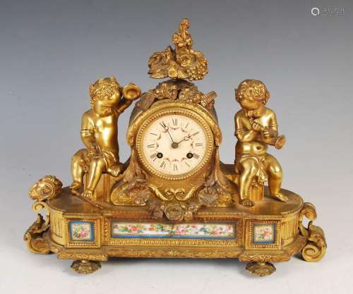 A 19th century Continental gilt metal mantle clock, the circ...