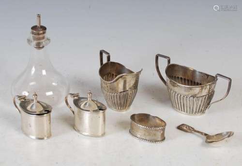 A group of silver, to include an Edwardian oval shaped sugar...