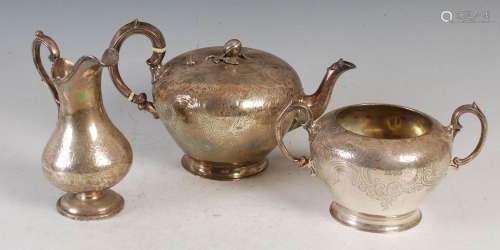 A Victorian silver three piece tea set, the tea pot and twin...