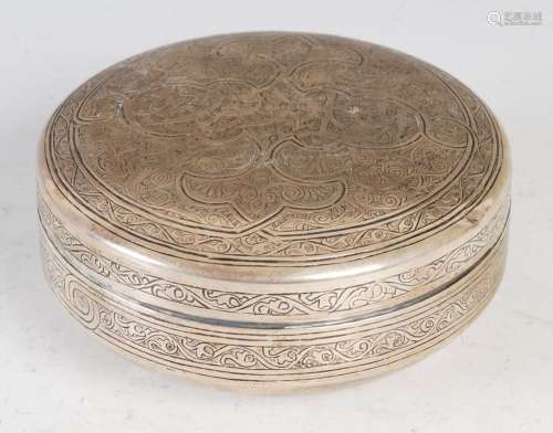 An Iraqi white metal/ silver circular shaped box and cover, ...