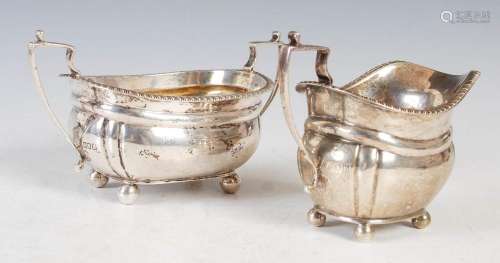 An Edwardian silver twin handled sugar bowl and matching cre...
