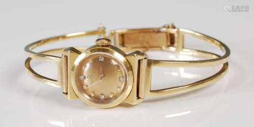 An 18ct gold and diamond set ladies Omega wristwatch, the ci...
