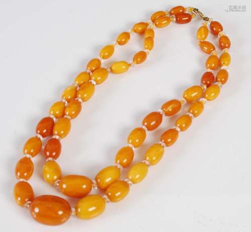 A graduated two strand Butterscotch amber necklace, of gradu...