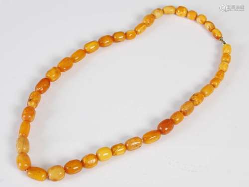 A Butterscotch amber necklace, formed form graduated oval be...