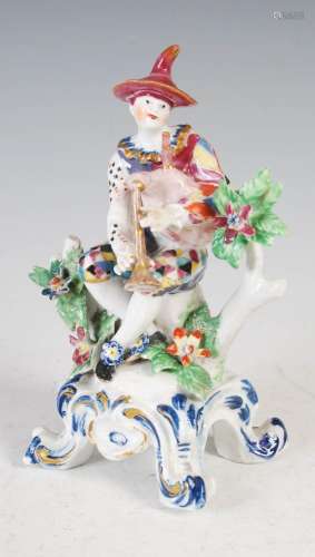 A Bow porcelain figure of a Harlequin playing the pipes, cir...